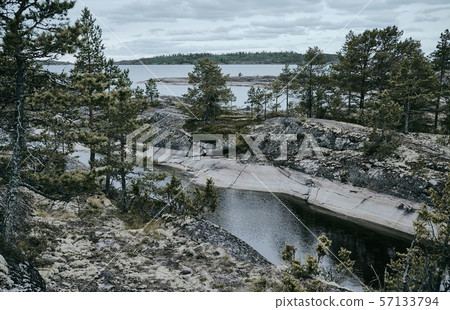 Rocky shore with pine trees. Ladoga skerries Rocky shore with pine trees. Ladoga skerries 57133794
