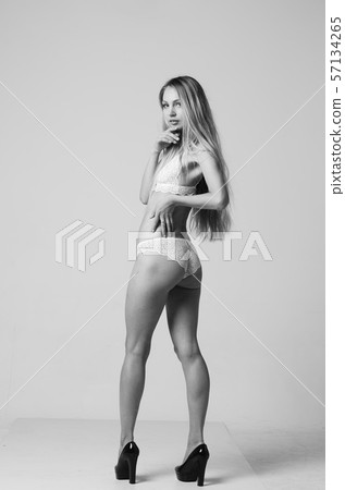 portrait of exquisite woman in lingerie sitting. portrait of exquisite woman in lingerie sitting. 57134265