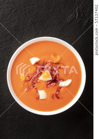 Salmorejo, Spanish cold tomato soup, shot from the top on a black background with copyspace 57137402