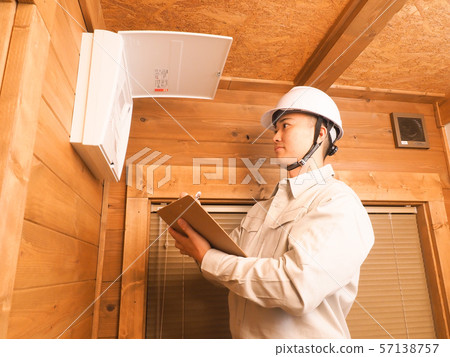 Worker checking the distribution board 57138757
