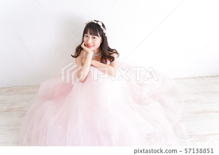 A smiling bride wearing a wedding dress 57138851