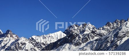 View on snowy rocks and blue clear sky at nice sun View on snowy rocks and blue clear sky at nice sun 57139286