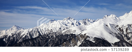 Panoramic view on snowy mountains in sun day Panoramic view on snowy mountains in sun day 57139289