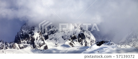 Mount Ushba in fog at sun winter day Mount Ushba in fog at sun winter day 57139372