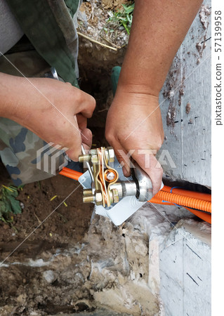 The master performs welding of a copper tube near The master performs welding of a copper tube near 57139958
