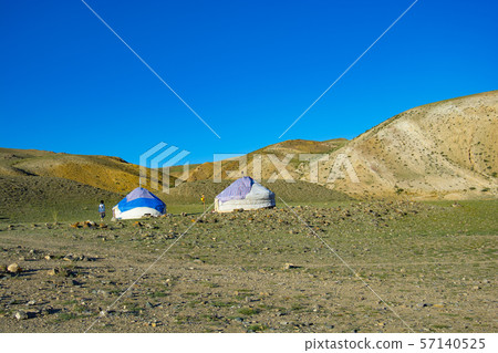 Yurta is set against the background of multi-colored mountains Yurta is set against the background of multi-colored mountains 57140525