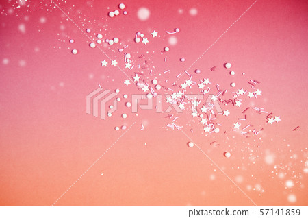 Colorful sprinkles on a pink background, top view with copy space 57141859