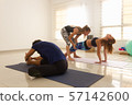 Yoga teacher assisting young girl in purvottanasana. Woman in upward plank pose in bright studio. Asana adjustment, sitting postures, exercise, workout class, healthy lifestyle concepts 57142600