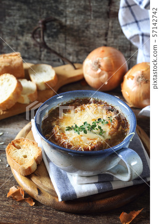 French onions soup with baguette, rustic style French onions soup with baguette, rustic style 57142742