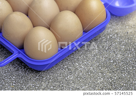 Chicken eggs in a blue plastic box.soft focus. 57145525