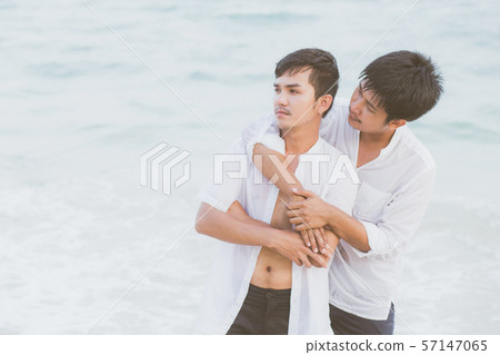 Homosexual portrait young asian couple standing problem on beach in summer Homosexual portrait young asian couple standing problem on beach in summer 57147065