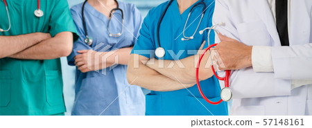 Doctor working in hospital with other doctors. 57148161