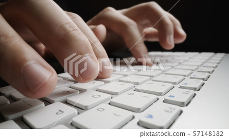 Close-up soft-focus finger typing on keyboard. Close-up soft-focus finger typing on keyboard. 57148182