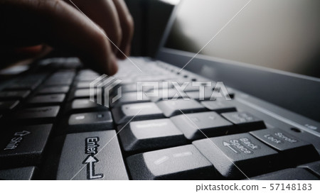 Close-up soft-focus finger typing on keyboard. Close-up soft-focus finger typing on keyboard. 57148183