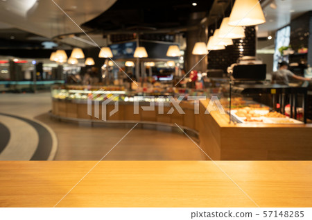 Wood table in blur background of modern restaurant Wood table in blur background of modern restaurant 57148285