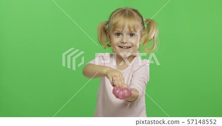 Kid playing with hand made toy slime. Child having fun making pink slime 57148552