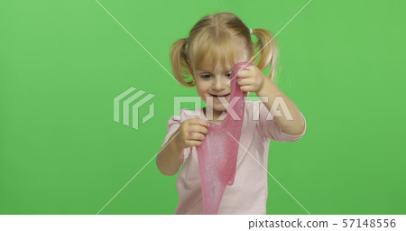 Kid playing with hand made toy slime. Child having fun making pink slime Kid playing with hand made toy slime. Child having fun making pink slime 57148556