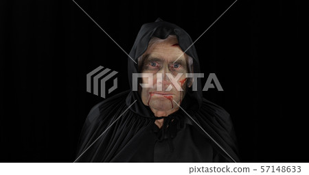Old executioner Halloween makeup and costume. Elderly man with blood on his face Old executioner Halloween makeup and costume. Elderly man with blood on his face 57148633
