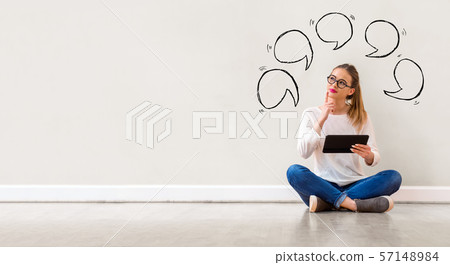 Speech bubbles with woman using a tablet 57148984