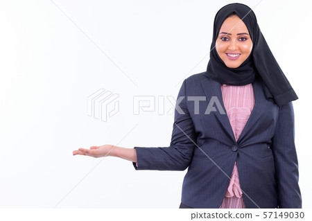 Happy young beautiful African Muslim businesswoman showing something Happy young beautiful African Muslim businesswoman showing something 57149030