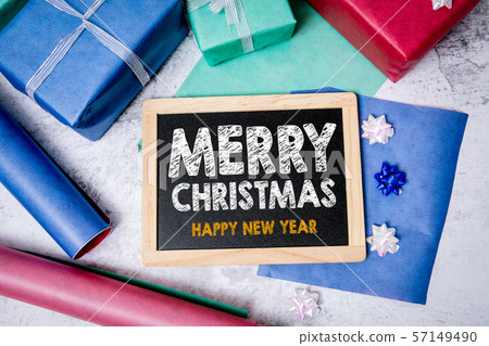Merry Christmas and Happy New Year greetings. Chalkboard, gifts and decorations 57149490