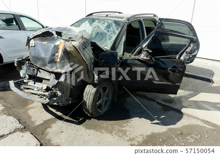 Seriously damaged vehicle near car service 57150054