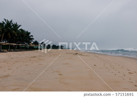 Buildings are visible across the sandy beach. Buildings are visible across the sandy beach. 57151691