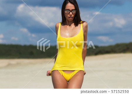 Beautiful woman in swimsuit on beach 57152550