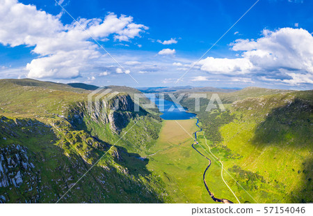 Aerial view of the Glenveagh National Park with castle Castle and Loch in the background - County 57154046