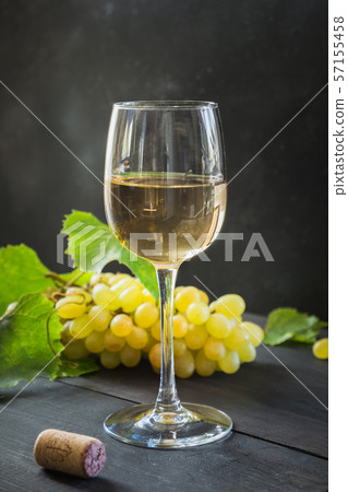 Bottle of white wine with wineglass, ripe grape. Bottle of white wine with wineglass, ripe grape. 57155458