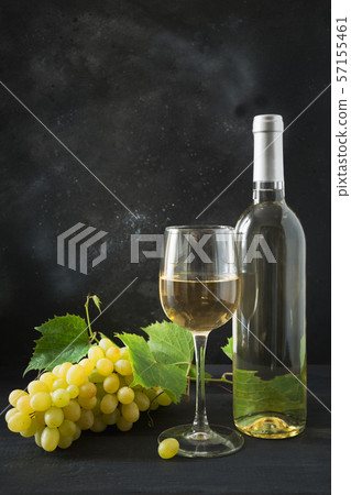 Bottle of white wine with wineglass, ripe grape. Bottle of white wine with wineglass, ripe grape. 57155461