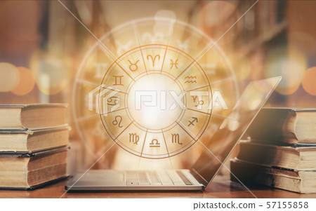 Zodiac sign horoscope astrology and constellation study for foretell and fortune telling education course concept with horoscopic wheel over old book and computer laptop in school library Zodiac sign horoscope astrology and constellation study for foretell and fortune telling education course concept with horoscopic wheel over old book and computer laptop in school library 57155858