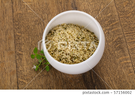 Peeled hemp seeds in the bowl Peeled hemp seeds in the bowl 57156002