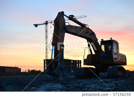 Large tracked excavator with hydraulic shears on a construction site Large tracked excavator with hydraulic shears on a construction site 57156250
