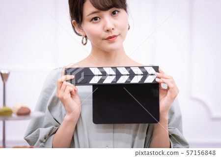 Actress filming clapperboard 57156848