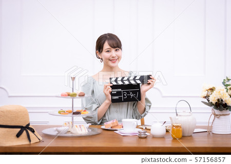 Actress filming clapperboard 57156857