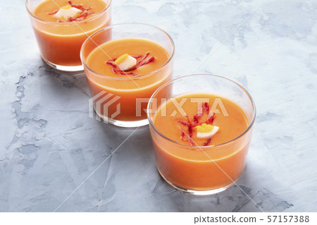 Salmorejo, Spanish chilled tomato and bread soup, served in glasses, with a place for text 57157388
