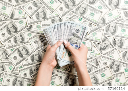 Top view of female hands counting money on dollar 57160114