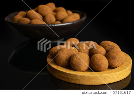 Chocolate cinnamon almond isolated on black glass Chocolate cinnamon almond isolated on black glass 57161617