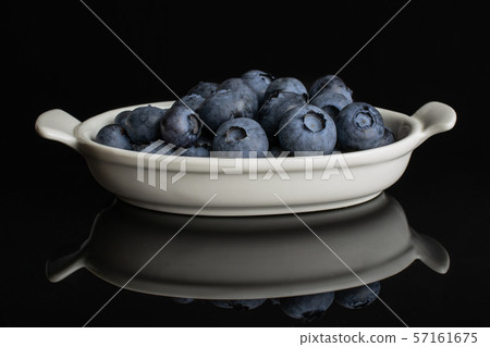 Fresj blue bilberry isolated on black glass Fresj blue bilberry isolated on black glass 57161675