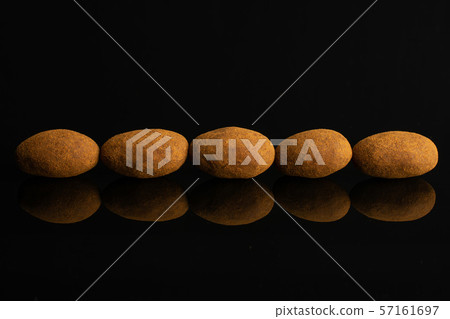 Chocolate cinnamon almond isolated on black glass Chocolate cinnamon almond isolated on black glass 57161697