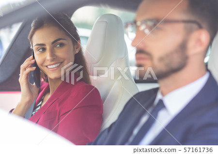 Beaming wife looking at her handsome husband driving car 57161736
