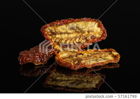 Red dried tomato isolated on black glass 57161799