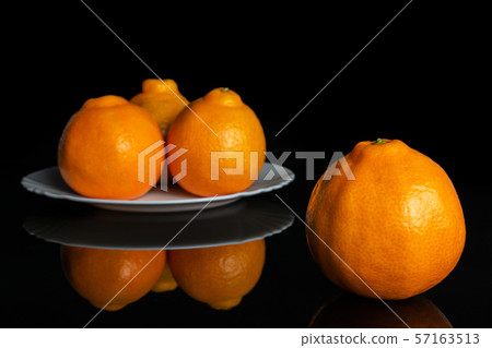 Orange minneola tangelo isolated on black glass 57163513