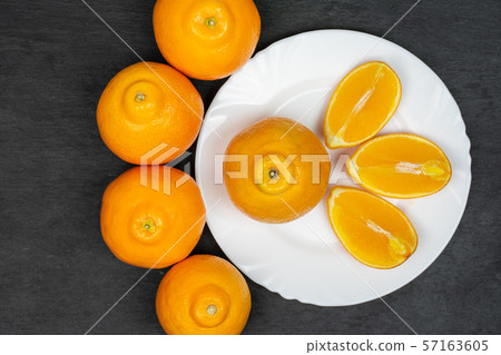 Orange minneola tangelo on grey stone Orange minneola tangelo on grey stone 57163605