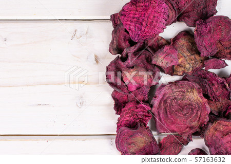 Dried red beetroot on grey wood Dried red beetroot on grey wood 57163632