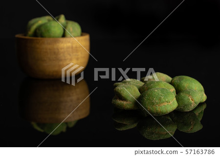 Green wasabi peanut isolated on black glass Green wasabi peanut isolated on black glass 57163786