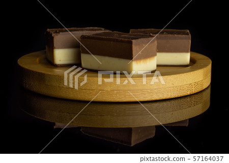 Two colours nougat isolated on black glass 57164037