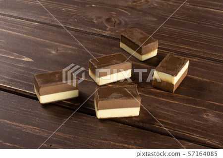 Two colours nougat on brown wood 57164085