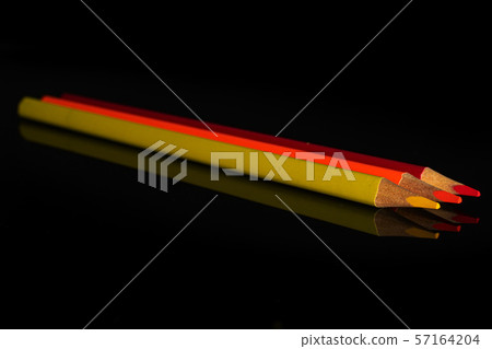Vibrant colored pencil isolated on black glass Vibrant colored pencil isolated on black glass 57164204